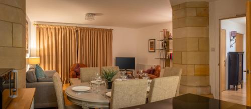 a dining room and living room with a table and chairs at Abbey Church 9 The Nave 2 bedroom Luxury Self catering apartment in Historic Abbey in Fort Augustus