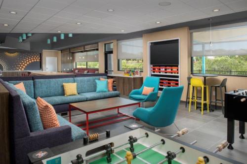 a living room with couches and a pool table at Tru By Hilton San Antonio North in San Antonio