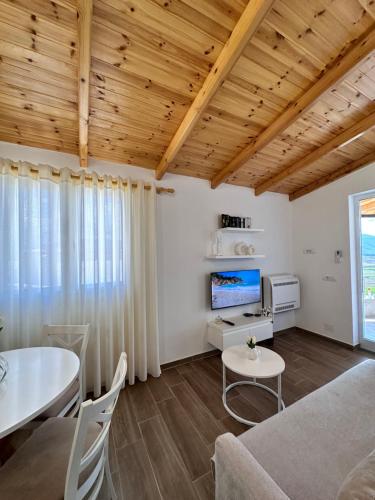 a living room with a couch and a table at Panoramic Views of Saranda in Sarandë