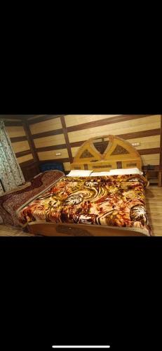 a bed with a wooden headboard at Royal stay in Srinagar