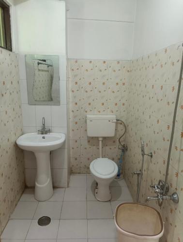 a bathroom with a toilet and a sink at Royal stay in Srinagar