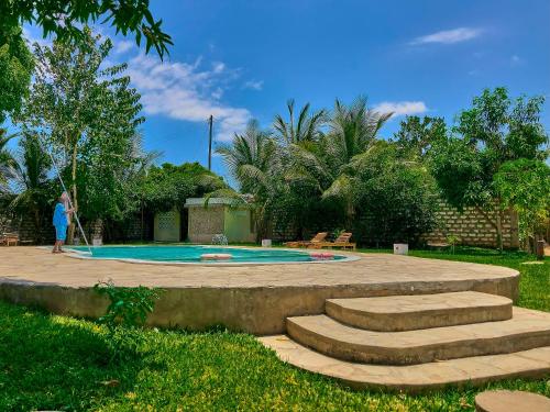 a person standing in front of a swimming pool at SHIMBA SPRINGS MBUYU. ( Malindi) in Malindi