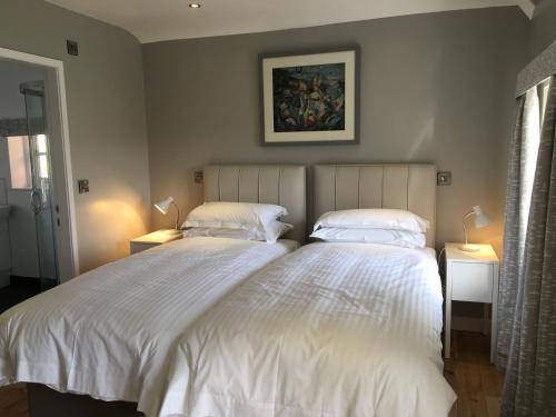 two beds sitting next to each other in a bedroom at Portmeirion Village & Castell Deudraeth in Porthmadog