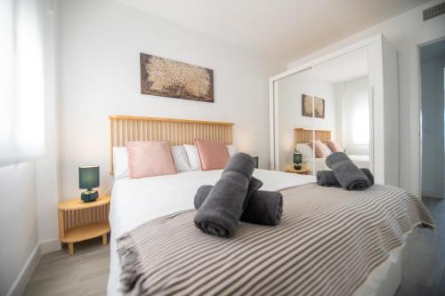 a bedroom with two beds with towels on them at Nordik Apartments Urban - Bellavista "Moskenes" in Málaga