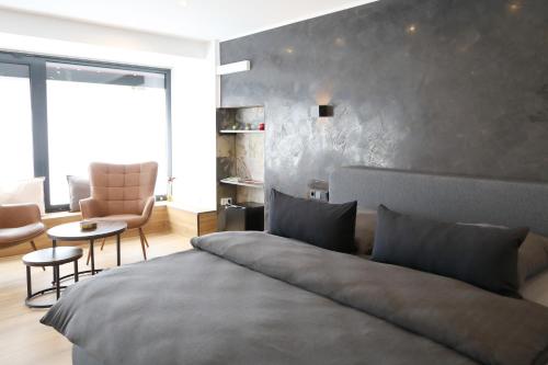 a bedroom with a bed and a table and chairs at Pension am Treiser Kiosk in Treis-Karden