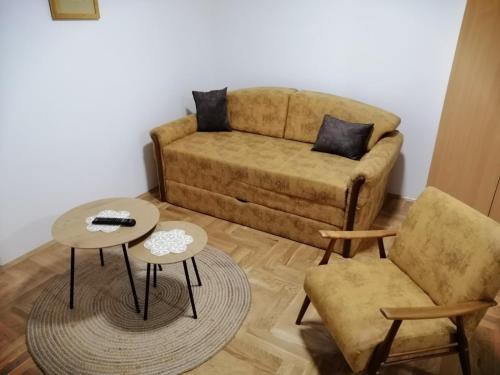 a living room with a couch and two tables at Stan na dan Jovana Šid in Šid