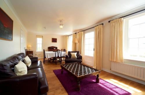 a living room with a couch and a table at Portmeirion Village & Castell Deudraeth in Porthmadog