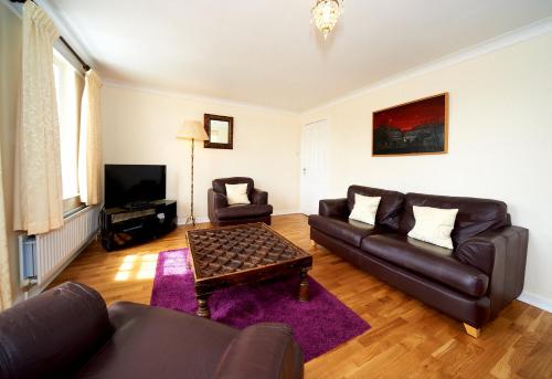 a living room with a couch and a table at Portmeirion Village & Castell Deudraeth in Porthmadog
