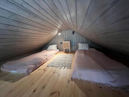 a room with two beds in a tent at Hytte Narie 1 in Morąg