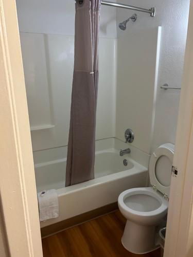 a bathroom with a toilet and a tub and a shower at Motel 6-Austin, TX - North Central in Austin