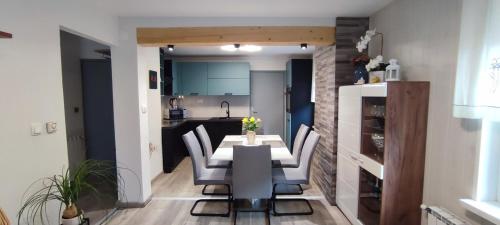 a kitchen and dining room with a table and chairs at Apartma Soča Oasis in Srpenica