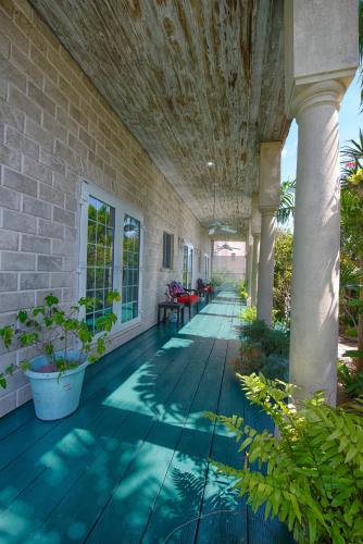 a porch of a house with plants on it at A Stone's Throw Away in Nassau