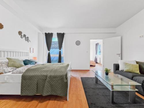 Habitación blanca con cama y sofá en sparkasse platz 8, en Stockerau