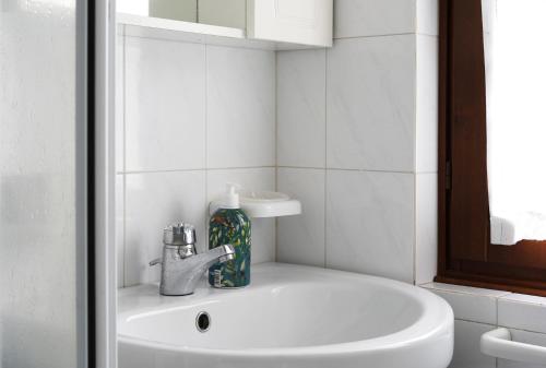 a bathroom with a sink and aaucet and a white sink at Lago Iseo View in Zone