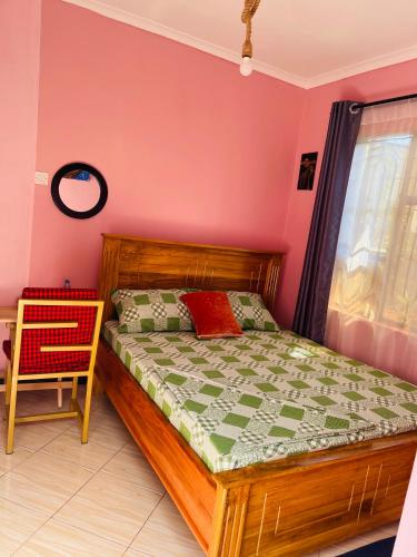 Postel nebo postele na pokoji v ubytování KILIMANJARO HOME OF RASON