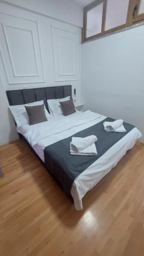 a bedroom with a large bed with two towels on it at Petreski Apartments 1 in Ohrid