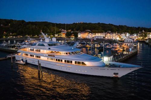 a large yacht docked in a marina at night at Danfords Hotel & Marina in Port Jefferson Station