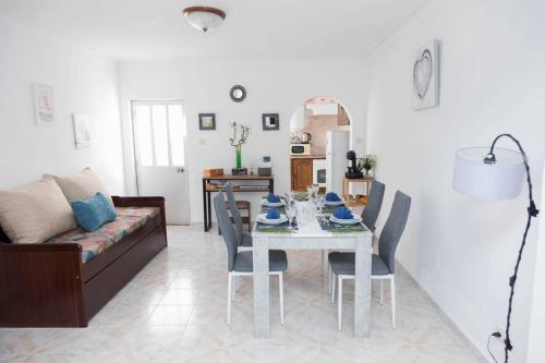 a living room with a table and a couch at Casa 'Saudade' in Moura