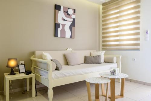 a living room with a couch and a table at Bellevue Suites in Agios Nikolaos