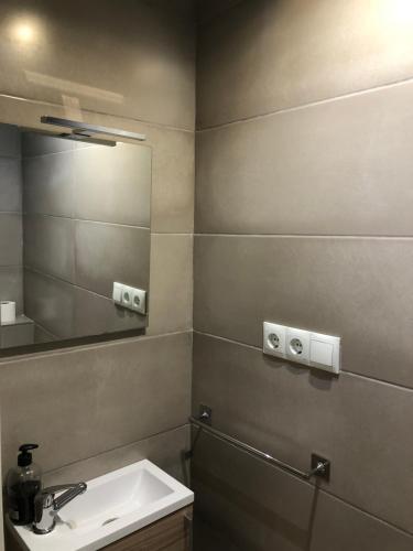 a bathroom with a sink and a mirror at Casa de Feliz in Calpe
