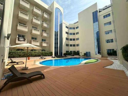 een groot gebouw met een zwembad voor een gebouw bij Luxury Studio/Apartment in JVC in Dubai