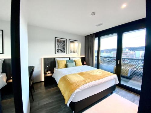 a bedroom with a large bed and a large window at GLAD Spot: Zurich - Central - Design - Netflix in Zurich