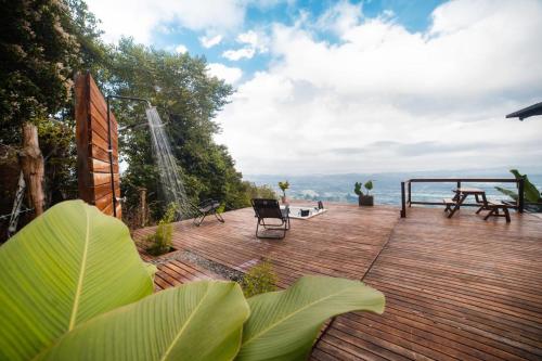 a wooden deck with a view of the water at El Refugio in Quindío