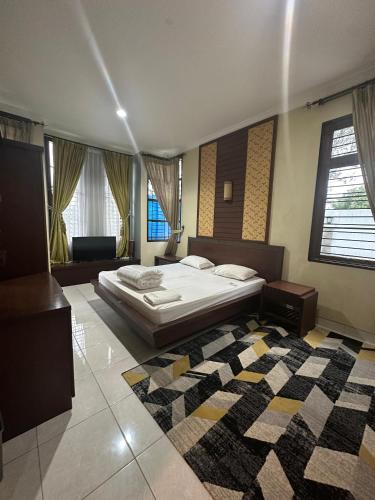 a large bedroom with a bed and a rug at Eton Asia Villas-Kota Bunga in Puncak