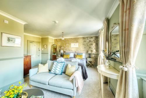 a living room with a couch and a bedroom at Hill House in Bath