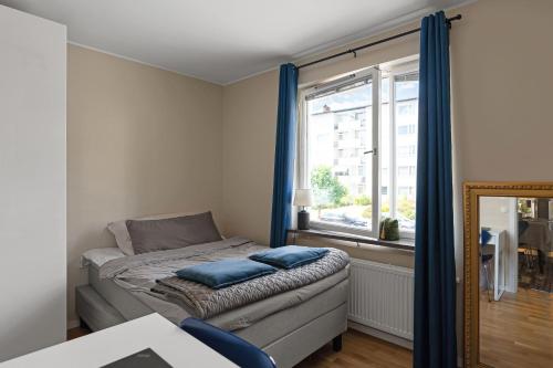 a small bedroom with a bed and a window at Danderyd/kevinge in Danderyd