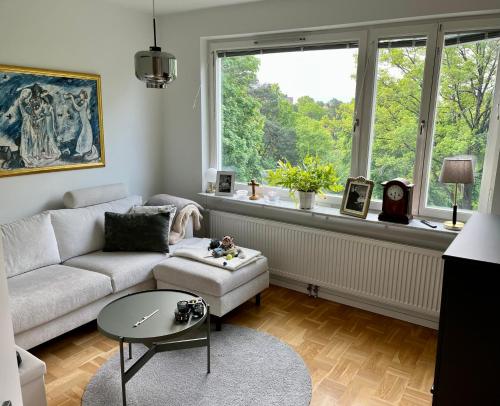 a living room with a couch and a window at Danderyd/kevinge in Danderyd