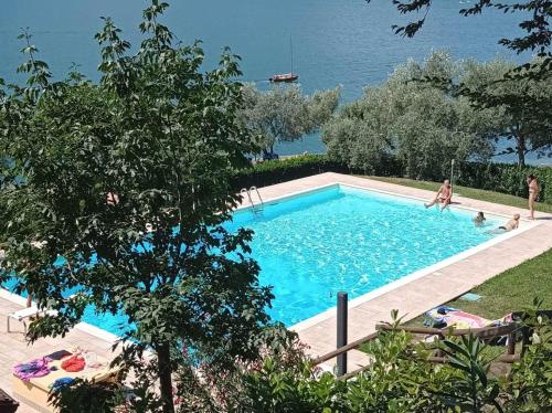 a swimming pool with a view of the water at Open space fronte lago in Monte Isola