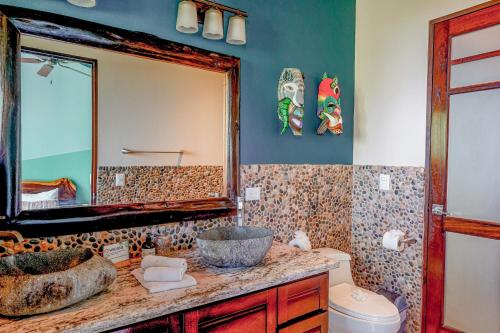 a bathroom with a sink and a mirror at Casa Vista Verde in Uvita