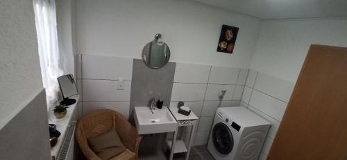 a bathroom with a sink and a washing machine at Bacchus in Hatzenport
