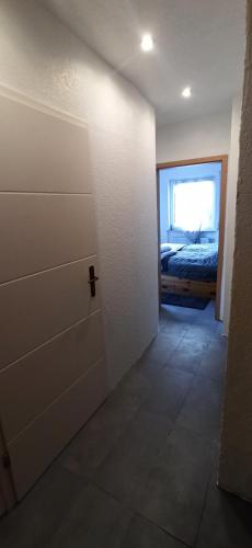 a room with a door and a bedroom with a bed at Bacchus in Hatzenport