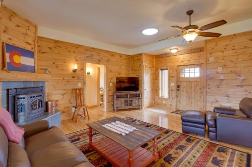 a living room with a couch and a fireplace at The Fox Den 360 Mtn View and On-Site Hiking! in Nathrop