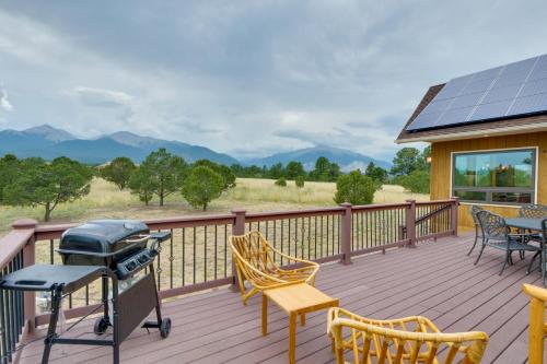 a grill on a deck with chairs and a table at The Fox Den 360 Mtn View and On-Site Hiking! in Nathrop