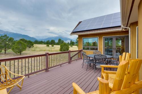 a deck with chairs and a table with solar panels at The Fox Den 360 Mtn View and On-Site Hiking! in Nathrop