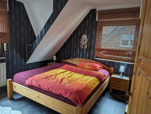 a bedroom with a large bed with a wooden headboard at Ferienwohnung Waldrand am See 