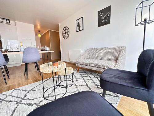 un salon avec un canapé et une chaise dans l'établissement Venise Centre 4 Chambres Parking, à Reims