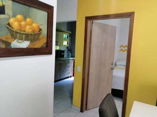 a kitchen with a painting of a bowl of fruit at apartamentos casa Margarita en laureles estadio su hogar en Medellin in Medellín
