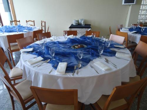 a table with a blue table cloth on it at Hotel Pombeira in Guarda