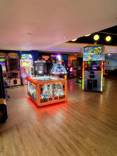 a room with lots of arcade games and machines at Serenity Coast in Wyke Regis