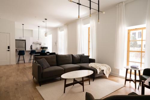 a living room with a couch and a table at Rasco by Luxury In Transit in Montréal