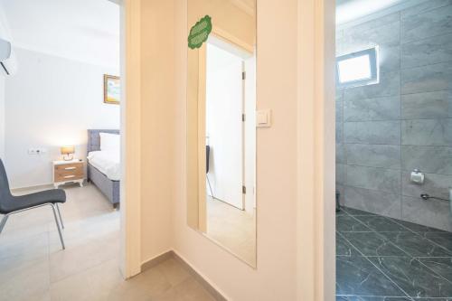 a bathroom with a mirror and a bedroom with a bed at Dedeminn Garden Hotel in Göcek
