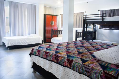a hotel room with a bed and two beds at Hotel Boutique Chateau de la Mar in Juan de Acosta