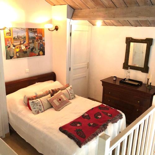 une chambre avec un lit avec une commode et un miroir dans l'établissement Grand loft avec piscine privée dans vielle gare, à Pomas