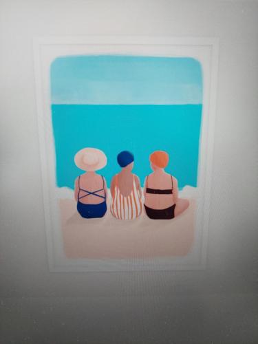 three figurines of three people in a picture frame at Vila Luka 2 in Hvar