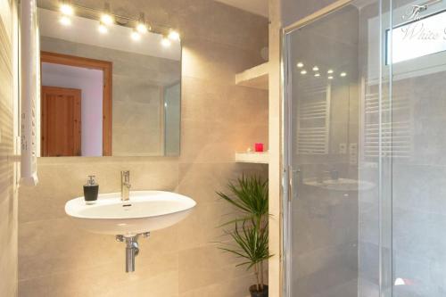 a bathroom with a sink and a shower at Waterfront villa with breathtaking views and pool in Colera