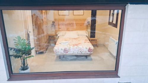 a view of a bedroom with a bed in a window at Caserio Kamirune in Laukiz